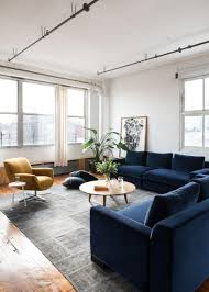 Interiors design of modern luxury bedroom and white wall pattern and side table. Deep Navy Sofas And Midcentury Modern Chair In Modern Loft Living Room Hgtv