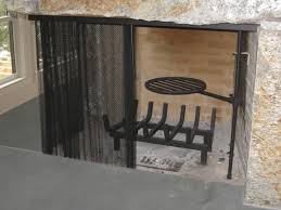 Steel fireplace freestanding hanging mesh curtain screen with brass finish and brass pulls on draw cord for opening and closing. Custom Fabricated Mesh Curtain Fireplace Screen