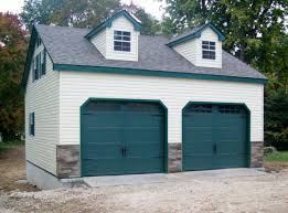 Garage door shopping can seem daunting. The Hunter Green Carriage Overhead Doors Really Finish Off This Garage Beautiful Stoltzfus Structures Garage Plans House Design