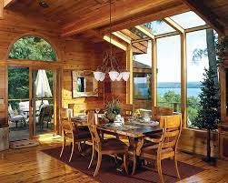 Dining room in log home with super high ceilings and large windows looking out onto elevated deck. 11 Ways To Create The Perfect Dining Area