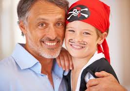 He Encourages His Son To Be Anything he Wants To Be. Portrait of a Father  with His Son Who is Dressed Up As a Pirate. Stock Photo