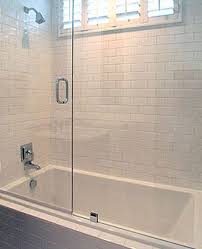 Clean Crisp White Bathroom With White Beveled Subway Tiles Shower Surround Glass Sliding Shower Doors And Shower Doors Tub With Glass Door Glass Shower Doors