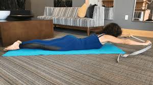 Lay On Your Belly And Extend Your Strap Overhead With Straight Arms Look Down At The Floor Holding Your Head This Way Will Str Yoga Props Beginner Poses Yoga