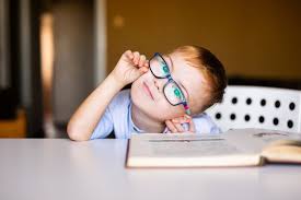 Use them in commercial designs under lifetime, perpetual & worldwide rights. Cute Toddler Boy With Down Syndrome With Big Glasses Reading Intesting Book Stock Photo Adobe Stock