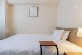 Queen size beds are 16 inches thinner, removing some personal space but will work well in smaller bedrooms. Interior Of Small Bedroom With Queen Size Bed Stock Photo Picture And Royalty Free Image Image 119456566