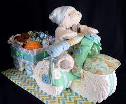 Trike Pulling A Wagon Diaper Cake The Wagon Is Filled With Goodies Www Facebook Com Diapercakesbydiana Diy Baby Shower Gifts Baby Shower Fun Baby Boy Wreath