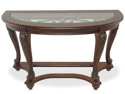 This oval coffee table set deserves a toast for incorporating so many elements so seamlessly. Norcastle Coffee Table By Ashley T499