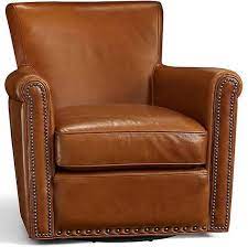 The faux leather, antique brass nailhead trim, and stitching detail create a stylish warmth for your home. Irving Leather Swivel Armchair Bronze Nailheads Polyester Wrapped Cushions Molasses At Pottery Barn Furnitur Leather Club Chairs Armchair Leather Armchair