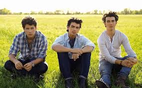 Three brothers from new jersey jonasbrothers.lnk.to/lbylm. Hd Wallpaper Jonas Brothers Grass Sun Field Look Young Adult Young Men Wallpaper Flare