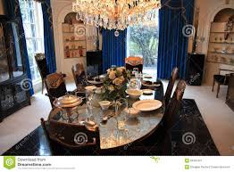 Choose a round pedestal table and armless dining chairs to visually enhance a space. Dining Room At Elvis Presley S Graceland Editorial Photo Image Of Billiards Pink 53487461