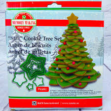 The house is decorated with garlands, candles, holly, and ivy. 3d Star Christmas Tree Cookie Cutter Set 10 Pc