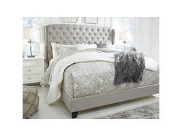 This wingback headboard bed is accented with hand tufting and hand applied nail head trims along the edges of the headboard, wings' silhouette, and footboard. Signature Design By Ashley Jerary King Upholstered Bed With Tufted Wing Headboard Royal Furniture Upholstered Beds