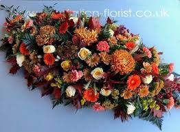 A selection of mixed flowers in shades of pink and blue including roses & lilies and germinis a lovely parting tribute to be placed on please note that due to the seasonal availability of flowers it may be necessary to vary individual stems from those shown. Autumn Coffin Spray Buy Online Or Call 01452 332203