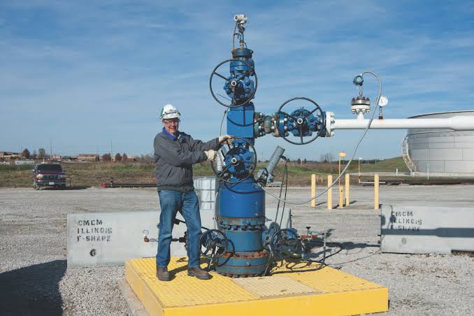 engineers reviewing monitoring data at an industrial carbon sequestration facility