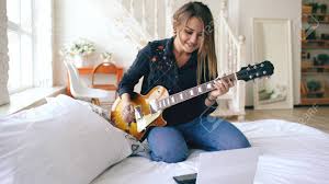 Sometimes i'll get the whole rig going if i need to work on some production. Attractive Young Girl Learning To Play Electric Guitar With Notebook Stock Photo Picture And Royalty Free Image Image 92361726