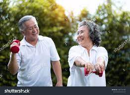Asian Senior Couple Exercising With Red Dumbbells At The Outdoor Park Togetherness Smiling Chinese Or Thai Or Japanese P Fit Couples Japanese Couple Couple Do