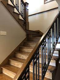 Red Oak Staircase With Metal Bars Complete Your Entry With Inviting Red Oak Steps And Intricate Metal Work Wooden Staircases Staircase Cabin Decor