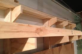 Here is the ladder in place in our diy rack on the garage ceiling and out of the way. How To Build A Wall Mounted Lumber Storage Rack
