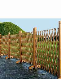 An uninterrupted line of boards stretches as far as the fence line runs with supporting posts. Expanding Wooden Fence Chums