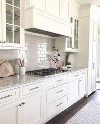 White Cream Kitchen Cabinets White Subway Tile Backsplash Built In Stovetop G In 2020 White Shaker Kitchen Cabinets Kitchen Cabinet Design Grey Kitchen Cabinets