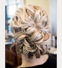 Braid the central section loosely and make a bun out of the braid. Updo Curly Hairstyles