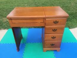 Very nice oak sewing machine cabinet from parsons with complimentary chair and a selection of thread. Elna Sewing Machine Cabinet