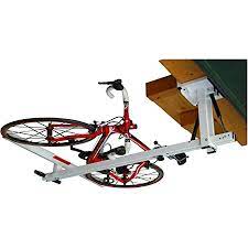 Bicycle hoisted and excess pulley rope attached to wall holder. Amazon Com Flat Bike Lift The New Overhead Rack To Store The Bikes Flat To The Garage Ceiling Home Improvement
