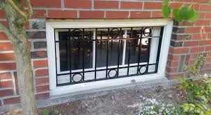 I love that the bars are on a hinge so they can be laid down against the wall if you need access to the window but lifted and secured when the window is not in use. Window Guards Ace Iron Works