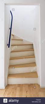 An Enclosed Staircase Surrounded With White Walls The Steps Are Made Of Birch Wood And The Risers Are Enclosed Staircase Enclosed Stairwell Decor White Walls