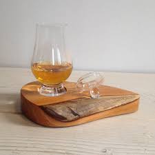 The whiskey glass, empty of liquid again, cigar in place again, but now turned sideways. Scottish Gift Whisky Glass Stand Wooden Gift Glencairn Etsy Whisky Glass Whisky Scottish Gifts