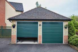 The stone cladding and the wood fence serve as neutrals, and because the siding color has so much gray in it, it also works as a neutral, allowing the bold green color of the home's entry to pop. Garage Doors Anglian Home Improvements