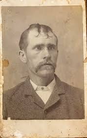 Do not know who this is in the adopted photo, but the picture begs the  question of how this man's wife allowed him out of the house with this  hairdo? ￼