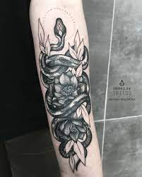 Snake And Lotus Tattoo On The Arm Snake Tattoo Tattoos Trendy Tattoos