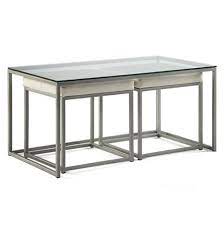 Cubic Nesting Coffee Table With Ottomans Creative Classics Two nesting ottomans, upholstered in faux leather, provide handy informal seating and a comfortable place to kick up your heels.