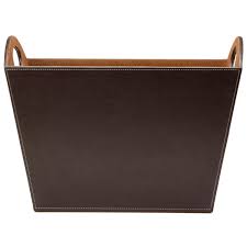 With its streamlined metal frame and leather hammock this sophisticated floor magazine rack is begging to be introduced to a contemporary or modern space. Osco Faux Leather Magazine Holder