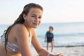Smiling teenage girl at sandy tropical beach, Grand Cayman Island. — people  in background, relaxation - Stock Photo | #309808670