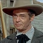 Robert Ryan. Great actor who excelled at playing steel hard tough guys.