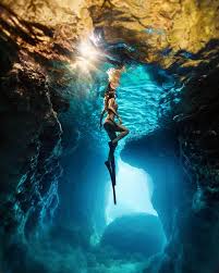 A Diver Is Exploring The Ocean Floor Underwater Photography Underwater Caves Underwater