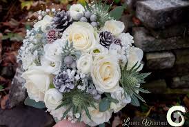 Winter Bouquet Of Roses Lisianthus Ranunculus Gypsophila Pine Cones And Thistle Laurel Weddings Laurel Wedding Winter Bouquet Wedding Bouquets Bride