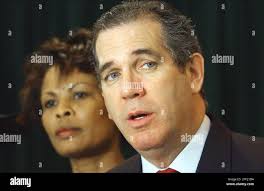 State Rep. Yolly Roberson, D-Miami, left, listens while Rep. Peter Deutsch,  D-Fla., tells the media in Miami Friday, Feb. 28,2004, that he supports  temporary protected stauts for Haitians as violence continues to
