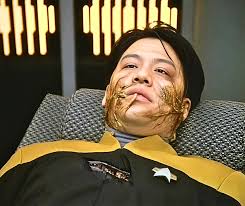 Ah, Harry Kim. The eternal ensign. The man who could get trapped in  alternate timelines, duplicate himself, die, get resurrected, impregnated  by an alien virus, and *still* not earn a promotion. If