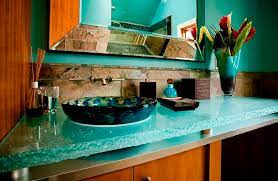 Side view of a green and brown bathroom design, vanity, large mirror, glass sink bowl, shower, tub, and pale green walls, and towel holder. Glass Vanity Top Poolside Powder Room Thinkglass