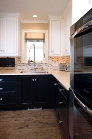 You can see that the rest of the colors in the kitchen are in the gray and white family (cooler colors) so the blue provides a great contrast. Black Lower And White Upper Cabinets Houzz