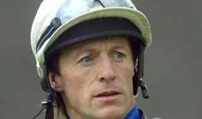 Jockey's wife 'kicked woman's head' in for sniggering at her