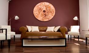 This dining room is styled with wooden framed blank wall art and carved wood decors mounted on serene dining room designed with ceramic plate decors mounted on the sky blue wall. 20 Captivating Maroon Living Room Ideas You Ll Adore