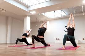 Yoga, meditation & labyrinth walk: Calm Women And Man Concentrated On Stretching Doing High Lunge Pose On Yoga Class Stockphoto