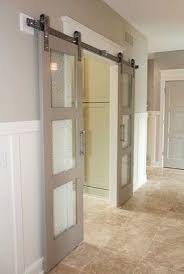 I Like This Idea Not With A Barn Door But Something More Contemporary Glass Paned Sliding Barn Doors Are A Modern Alternative To Tradition Living Barn Style Doors Home Barn