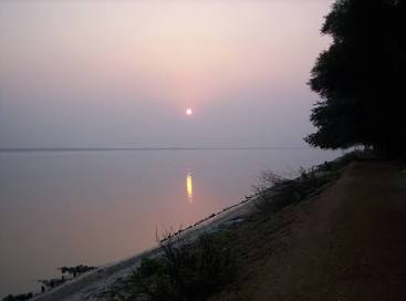 Serene river sunset over Gadiara, AI generated