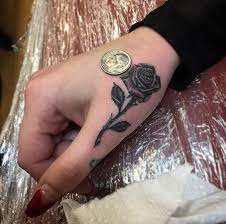 Rose Tattoo On Finger By The Black Rooster Hand Tattoos Rose Tattoos Tattoos