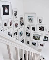 Black And White Gallery Wall Stairs Liven Up The Staircase Area In Your Home With An Asymmetric Gallery Wall Designgram Truthandco Truthan Stair Photo Walls Frames On Wall Staircase Wall Decor